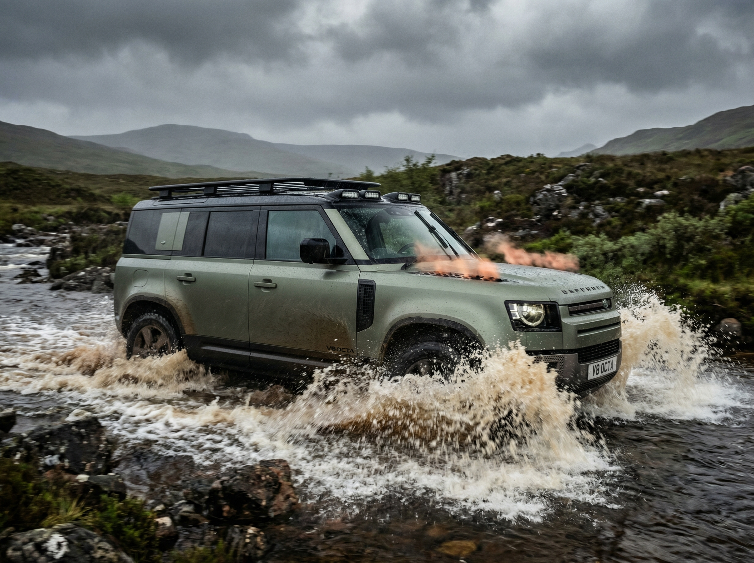 Land Rover Defender OCTA charging through water crossing
