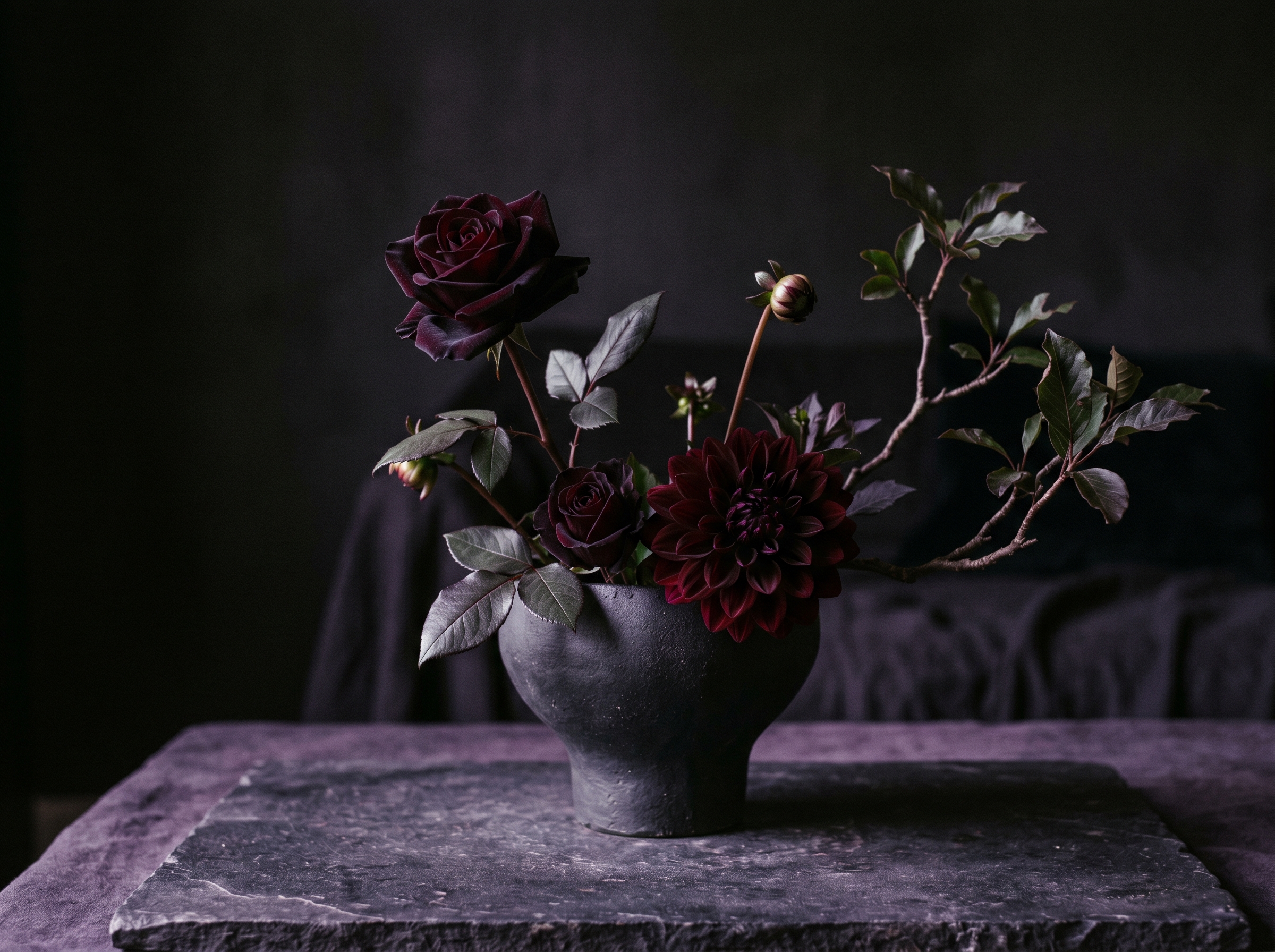 Dark dahlias and Black Baccara roses in an architectural arrangement