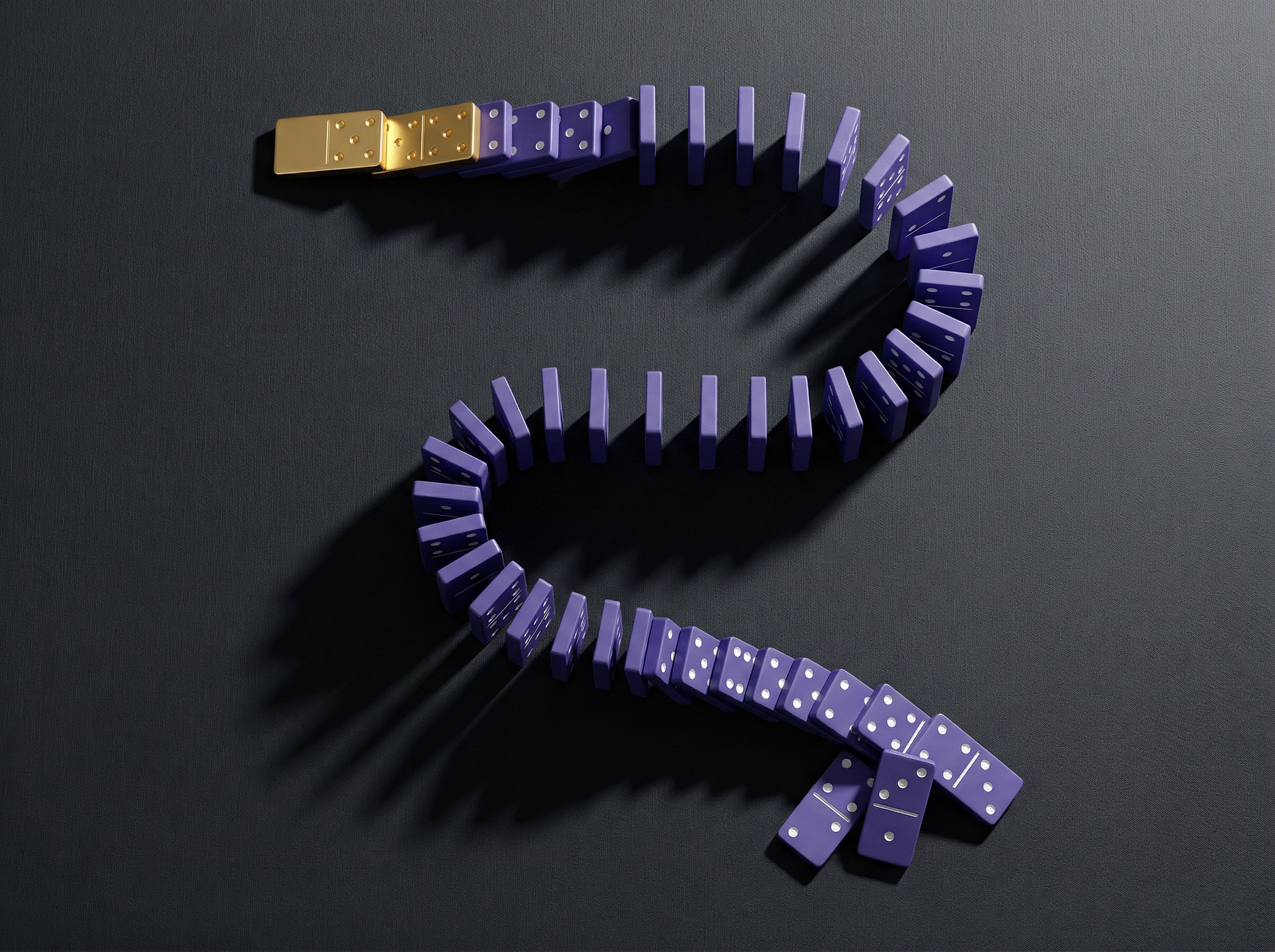 Overhead view of domino pieces cascading in a chain reaction, the first gold-colored and larger, the rest violet — representing the policy domino effect