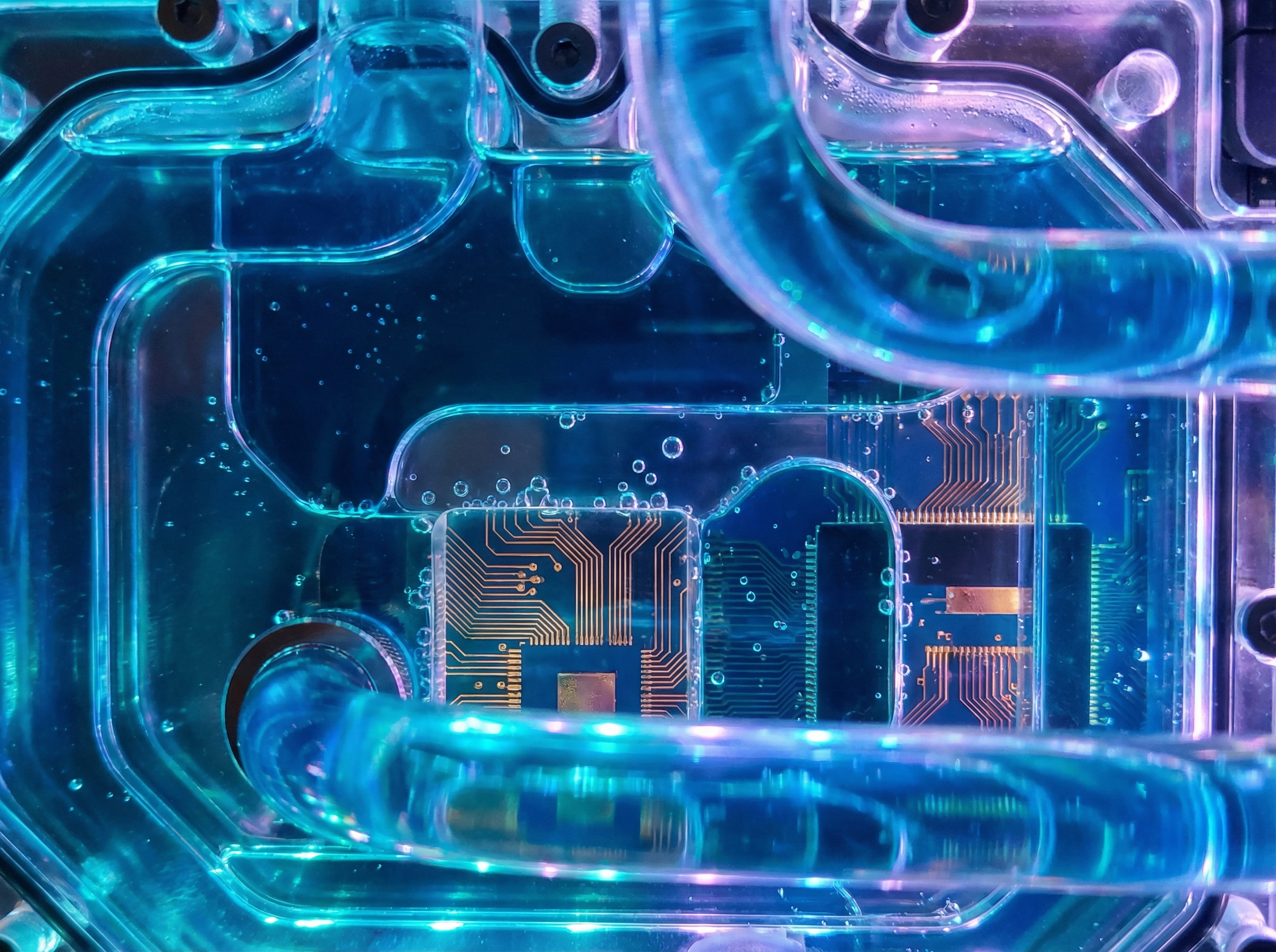 GPU chips submerged in glowing blue cooling fluid